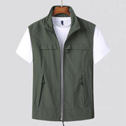 Drip Guard sleeveless zip-up vest with multiple pockets in olive green over white t-shirt, designed for protection and clean surfaces.