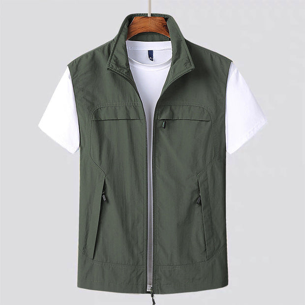 Drip Guard sleeveless zip-up vest with multiple pockets in olive green over white t-shirt, designed for protection and clean surfaces.