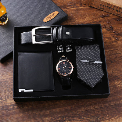 Quartz wristwatch gift set with black leather strap, wallet, belt, tie, and cufflinks in black packaging box on wooden surface