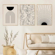 Boho Canvas trio of abstract line art prints with minimalist black and beige designs in a cozy living room setting