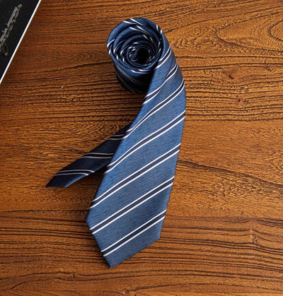 Navy blue men's polyester tie with white diagonal stripes on wooden surface