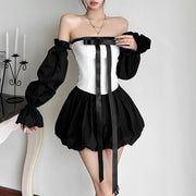 Woman wearing Bow Tique black and white off-shoulder bud skirt with bow detail and puff sleeves