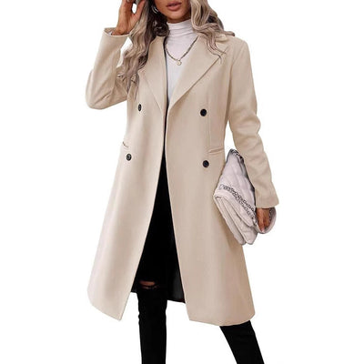 Woman wearing beige double-breasted long autumn and winter coat with pockets and regular sleeves.